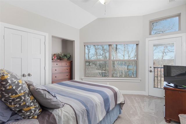 bedroom with access to exterior, visible vents, lofted ceiling, carpet floors, and a ceiling fan