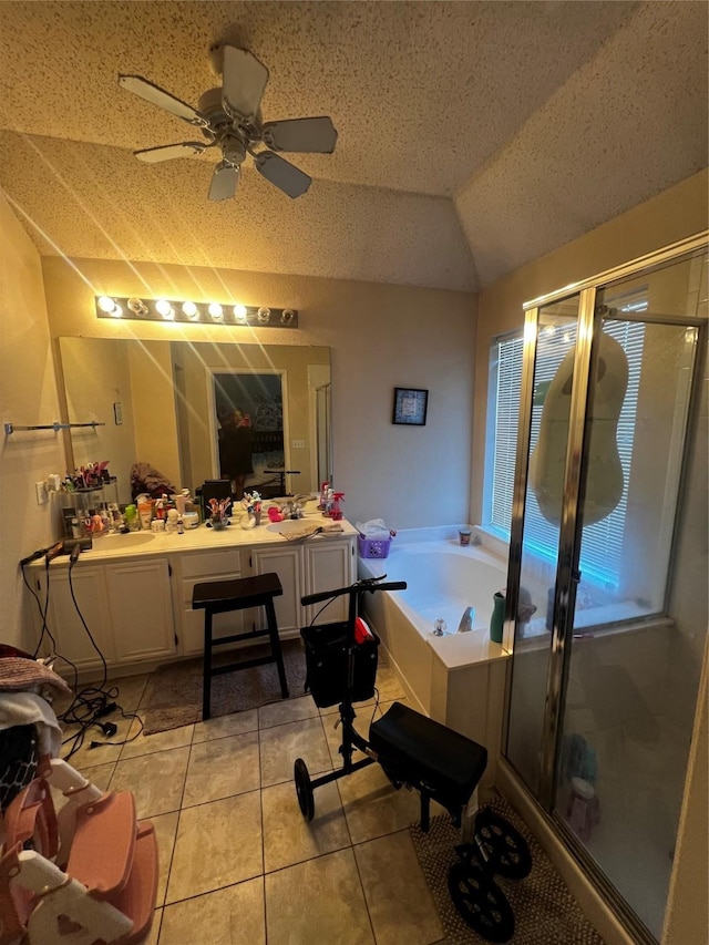 bathroom featuring vanity, lofted ceiling, a garden tub, and a shower stall