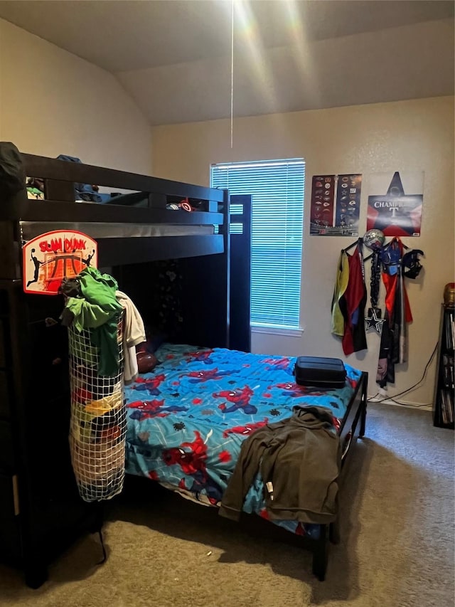 carpeted bedroom with lofted ceiling