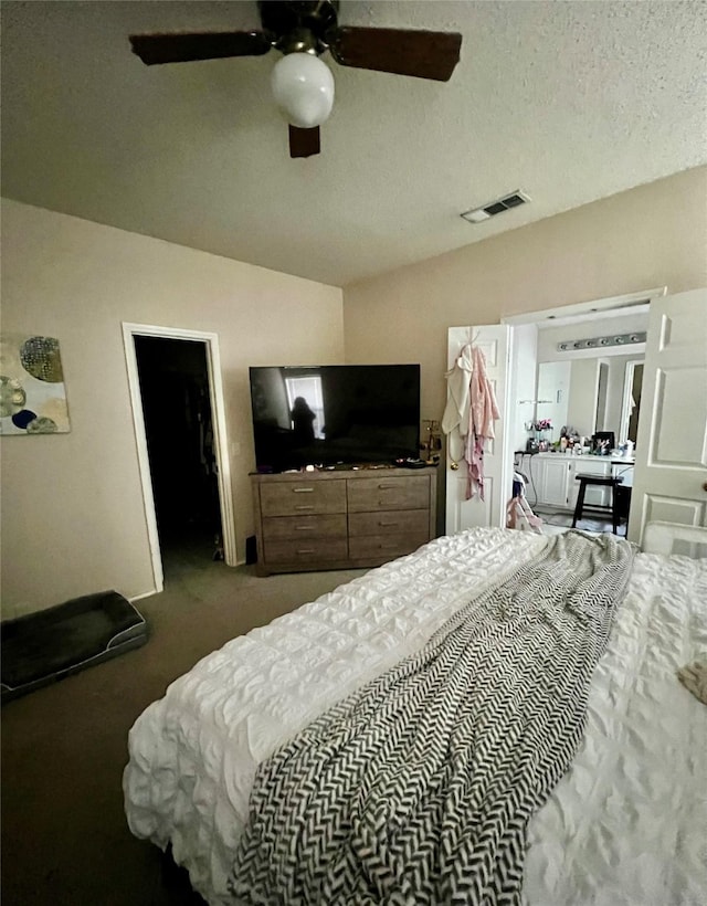 bedroom with visible vents, a textured ceiling, a ceiling fan, and vaulted ceiling