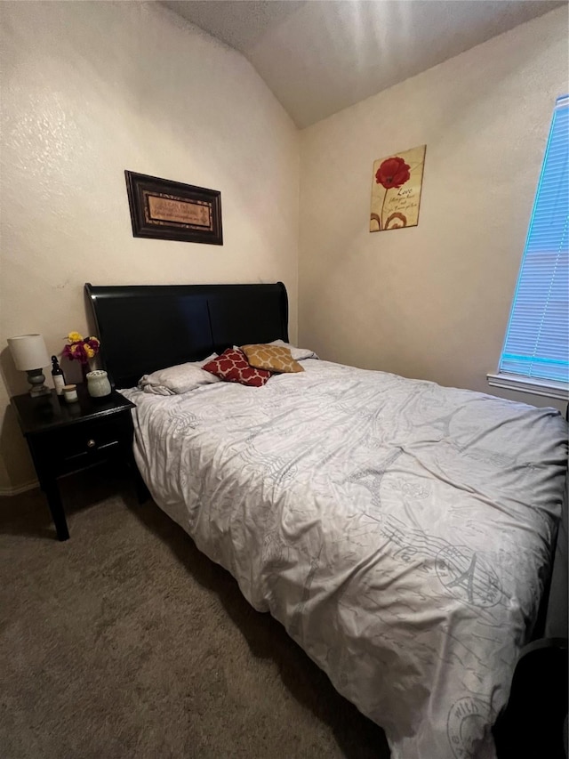 carpeted bedroom featuring vaulted ceiling