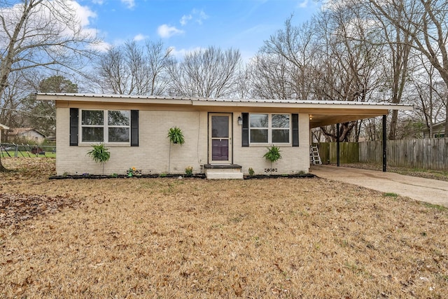 single story home with an attached carport, fence, driveway, entry steps, and brick siding