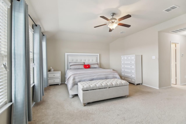 bedroom featuring visible vents, light carpet, baseboards, and a ceiling fan