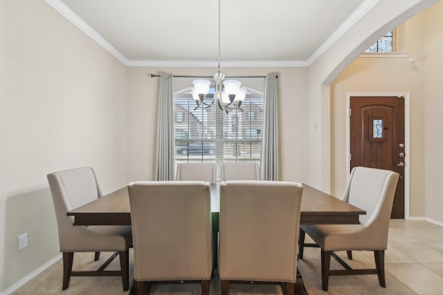 dining area with light tile patterned floors, baseboards, arched walkways, crown molding, and a chandelier