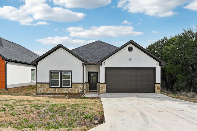 view of front of home with roof with shingles, driveway, an attached garage, stucco siding, and stone siding