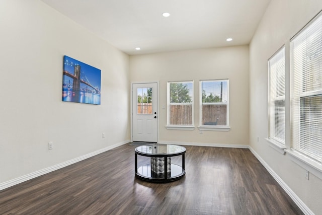 unfurnished room with recessed lighting, dark wood-style floors, and baseboards