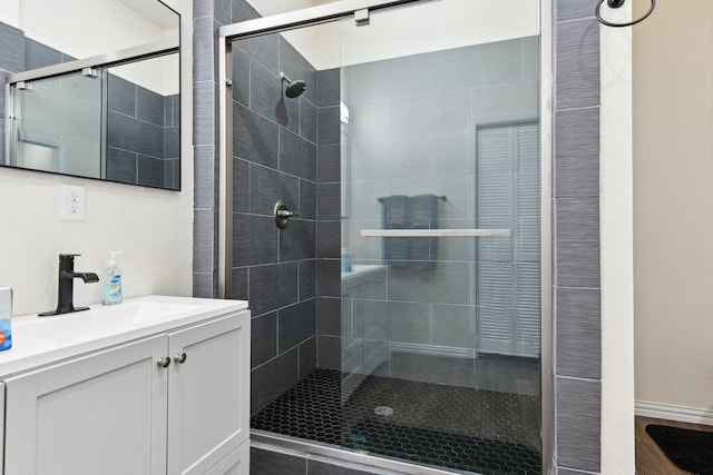 bathroom with a stall shower and vanity