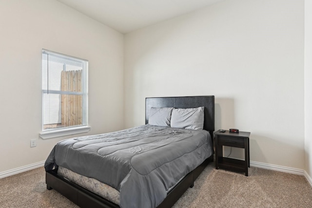 bedroom featuring baseboards and carpet