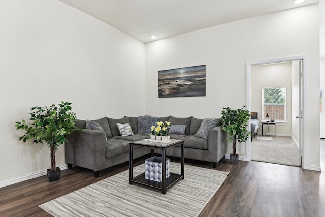 living room with recessed lighting, baseboards, and dark wood-style flooring