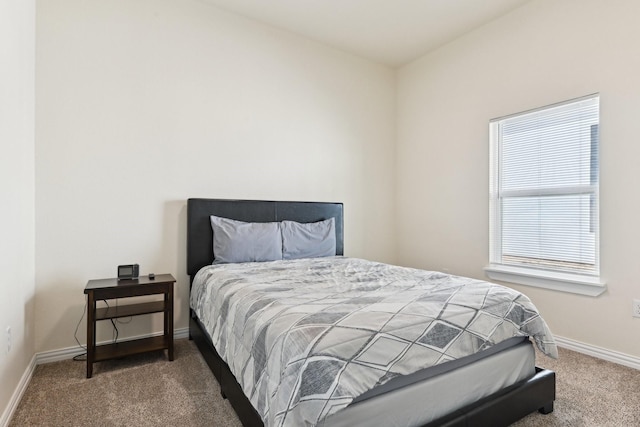 bedroom featuring baseboards and carpet floors