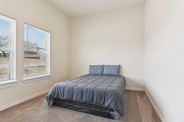 carpeted bedroom featuring baseboards