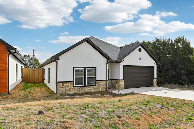 view of front facade featuring stone siding, stucco siding, concrete driveway, and a garage