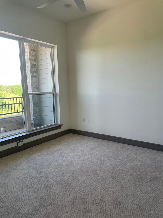 spare room with baseboards, carpet, and ceiling fan