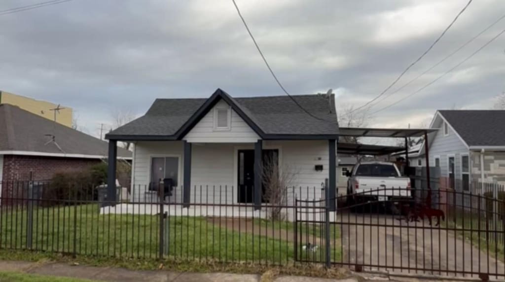 bungalow-style home with a fenced front yard, a porch, and a front yard