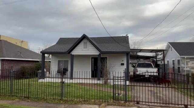 bungalow-style home with a fenced front yard, a porch, and a front yard