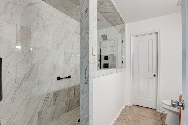 bathroom with toilet, baseboards, and walk in shower