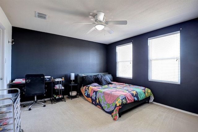 bedroom featuring visible vents, baseboards, a ceiling fan, and carpet flooring