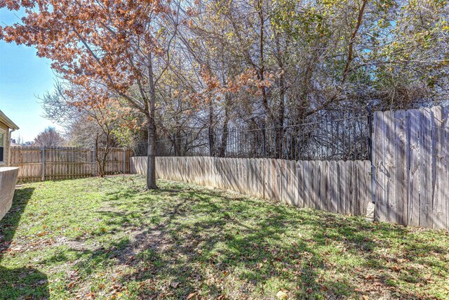 view of yard with a fenced backyard