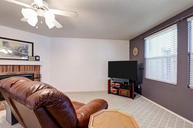 living room with ceiling fan, a fireplace, baseboards, and carpet