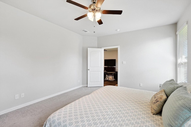 carpeted bedroom featuring a ceiling fan, baseboards, and visible vents
