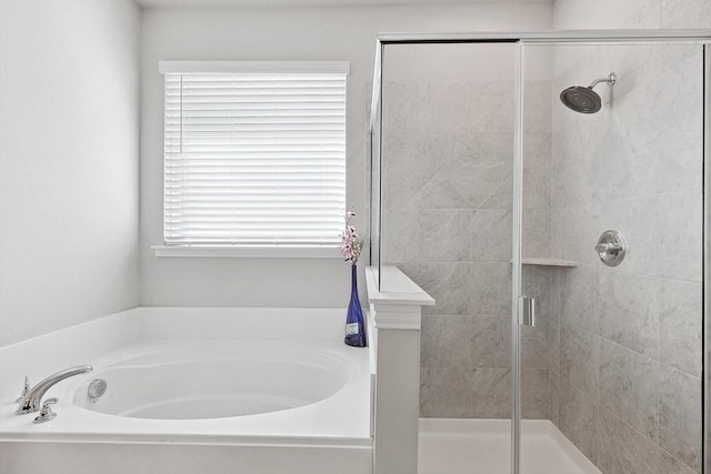 bathroom featuring a garden tub and a stall shower