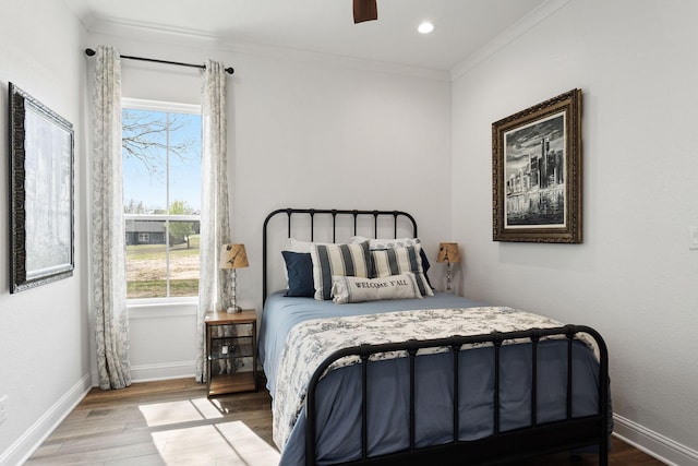 bedroom with ornamental molding, wood finished floors, recessed lighting, baseboards, and ceiling fan