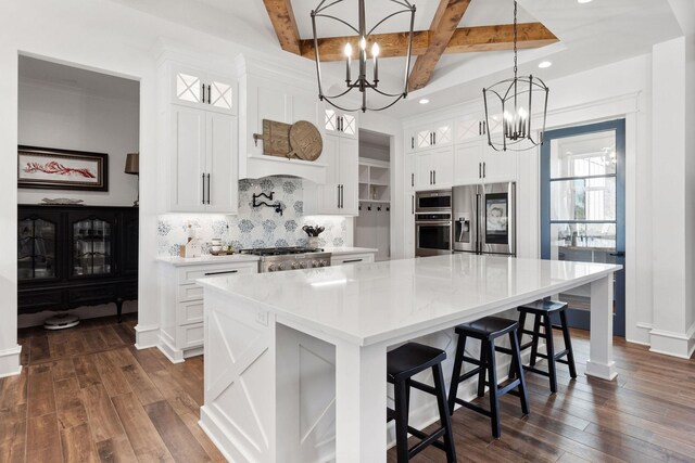 kitchen featuring a spacious island, stainless steel appliances, glass insert cabinets, and dark wood-type flooring