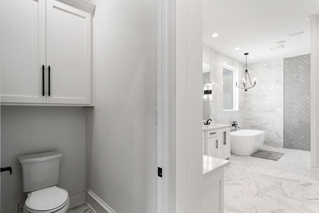 bathroom with vanity, a freestanding tub, recessed lighting, toilet, and marble finish floor