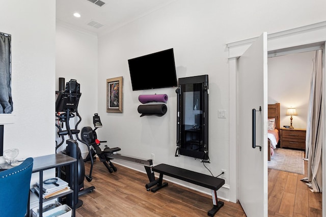 workout room featuring visible vents, recessed lighting, ornamental molding, and wood finished floors