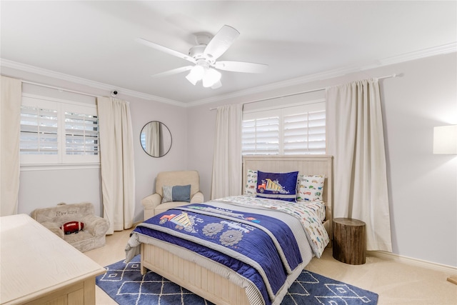 carpeted bedroom featuring ceiling fan and ornamental molding