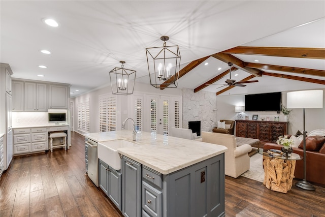 kitchen with backsplash, gray cabinetry, dark wood-type flooring, lofted ceiling with beams, and a sink