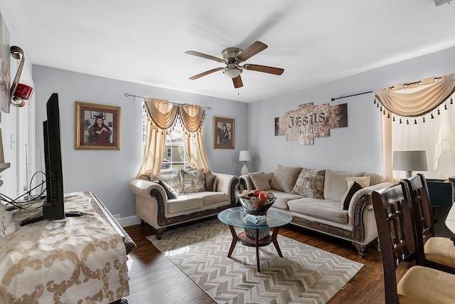 living area with ceiling fan, baseboards, and dark wood-style floors