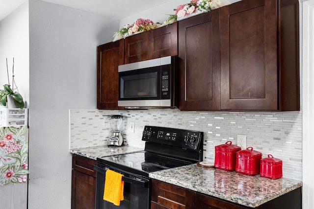 kitchen with light stone counters, black electric range, dark brown cabinets, stainless steel microwave, and tasteful backsplash