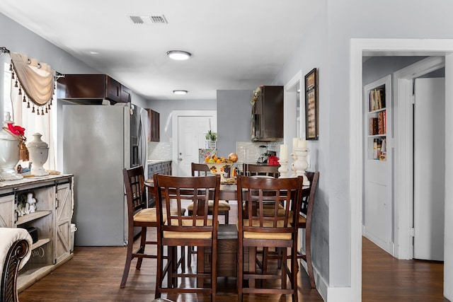 dining room with dark wood-type flooring and visible vents