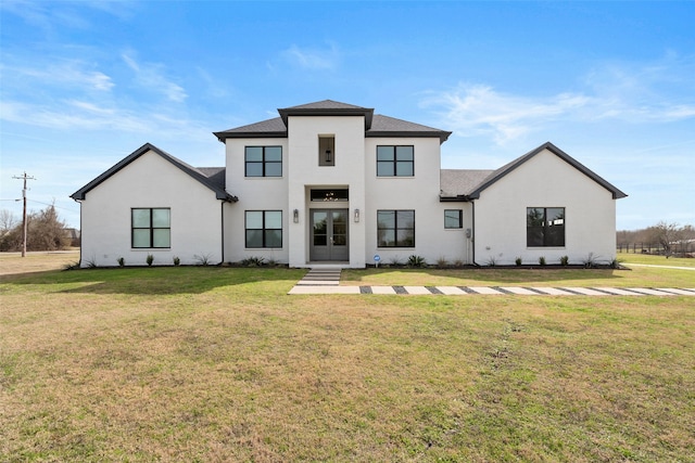 view of front facade with a front yard and stucco siding