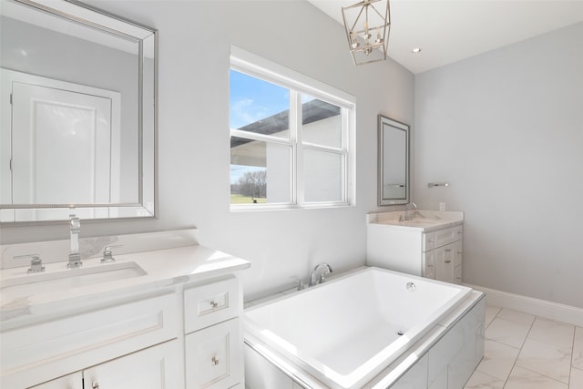 full bathroom featuring baseboards, a bathing tub, two vanities, a sink, and marble finish floor