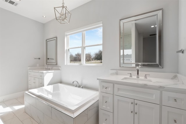 bathroom featuring visible vents, a garden tub, two vanities, marble finish floor, and a sink