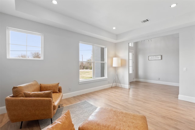 living area with recessed lighting, visible vents, baseboards, and light wood-style floors