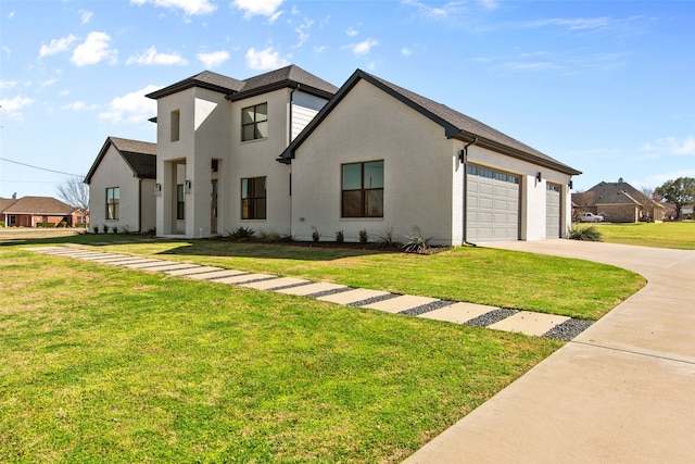 view of front of property featuring a front lawn, concrete driveway, and a garage