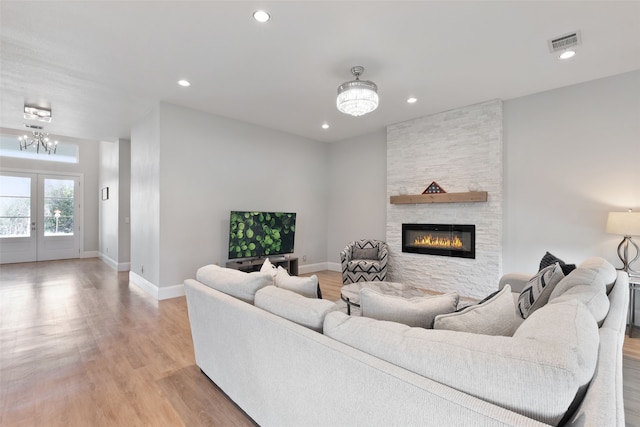 living room featuring recessed lighting, visible vents, french doors, and light wood finished floors