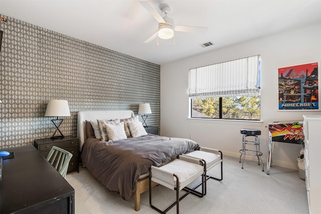 bedroom with visible vents, light carpet, wallpapered walls, baseboards, and an accent wall