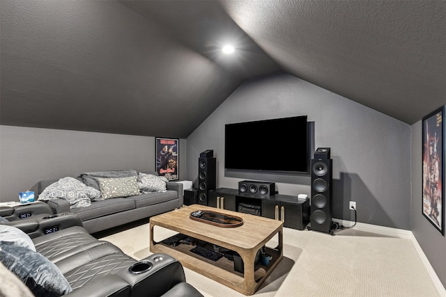 carpeted home theater with a textured ceiling, lofted ceiling, and baseboards