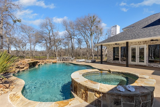 view of pool with a patio, french doors, and a pool with connected hot tub