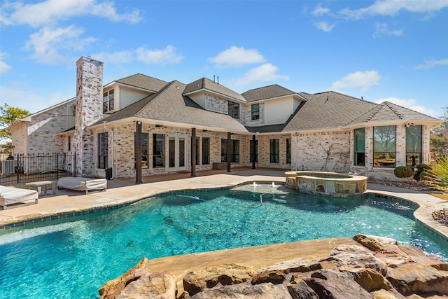 view of swimming pool featuring a patio, french doors, fence, and a pool with connected hot tub