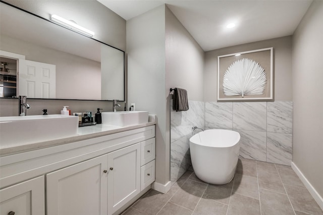 1818 Engle Ave, Dallas, TX 75224 - full bath featuring tile walls, a freestanding bath, double vanity, tile patterned flooring, and wainscoting