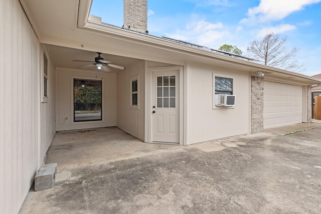 entrance to property featuring cooling unit, a chimney, and a ceiling fan