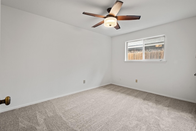 unfurnished room featuring carpet flooring, baseboards, and ceiling fan