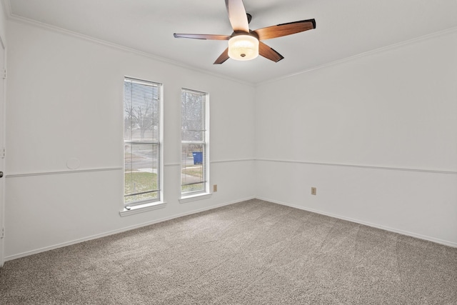 unfurnished room featuring baseboards, a ceiling fan, carpet flooring, and crown molding