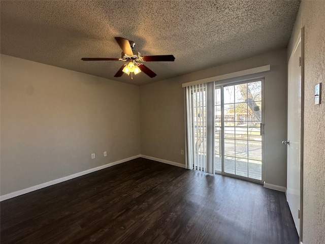 empty room with ceiling fan, dark wood-type flooring, baseboards, and a textured ceiling