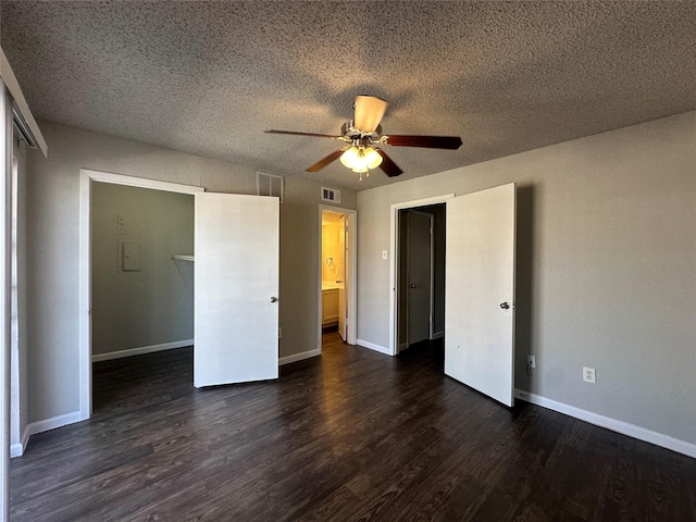 unfurnished bedroom with a closet, dark wood-style floors, and baseboards